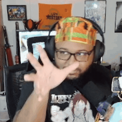 Man With Headphones And Headband Gesturing In Front Of Can History Sign GIF