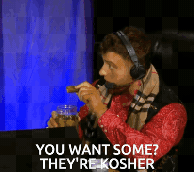 Man With Headphones And Scarf Says You Want Some They're Kosher While Eating GIF