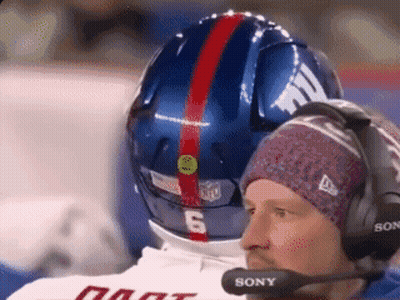 Man With Headphones And Sony Microphone Looking At Football Helmet GIF