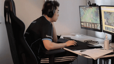 Man With Headphones And Specs Shirt At Two Monitors GIF