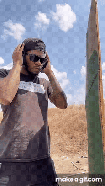 Man With Headphones And Sunglasses In Field GIF