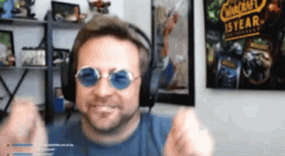 Man With Headphones And Sunglasses In Front Of Warcraft Poster GIF