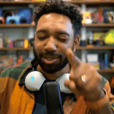Man With Headphones Around Neck Pointing GIF