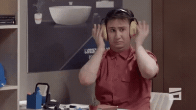 Man With Headphones At Desk GIF