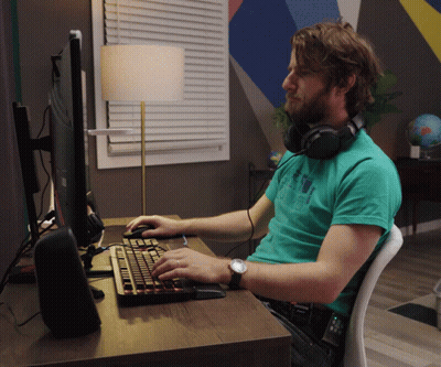 Man With Headphones at Desk With Keyboard