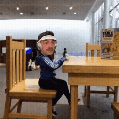 Man With Headphones At Table With Table 4 Grains Can GIF