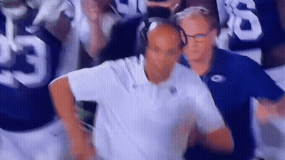 Man With Headphones Before Football Players GIF