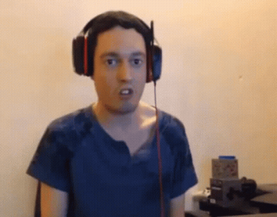Man With Headphones Funny Face At Desk GIF