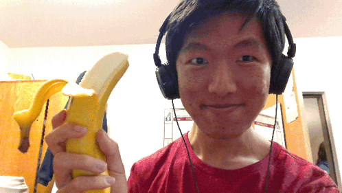 Man With Headphones Holding Banana And Smiling GIF