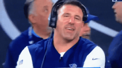 Man With Headphones Holding Clipboard In Front Of NFL Logo GIF