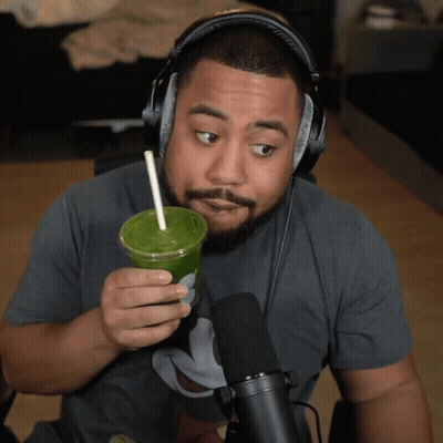 Man With Headphones Holding Green Drink GIF