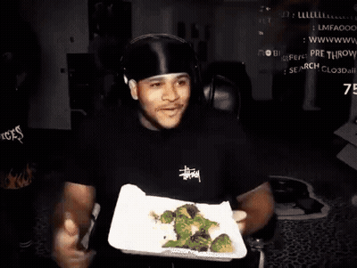 Man With Headphones Holding Plate Of Broccoli GIF