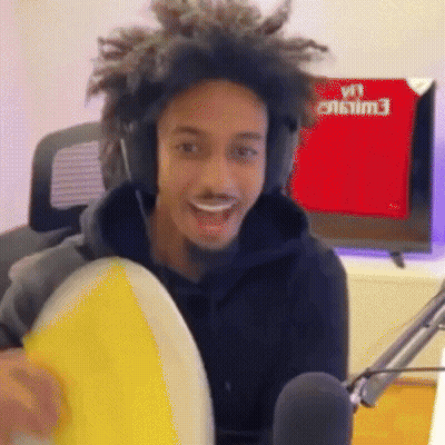 Man With Headphones Holding Yellow Frisbee At Microphone GIF