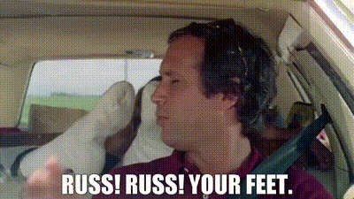 Man With Headphones In Car Saying Russ Russ Your Feet GIF