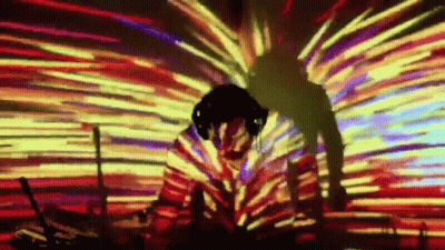 Man With Headphones In Front Of Colorful Lights GIF