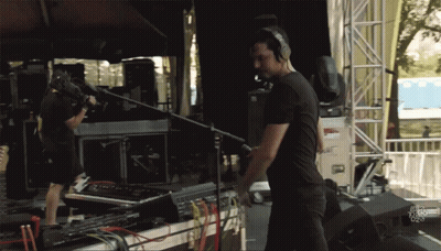 Man With Headphones In Front Of Fox News Sign GIF