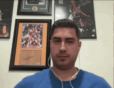 Man With Headphones In Front Of Framed Basketball Picture Signed By Brad Jackson GIF