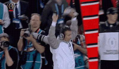Man With Headphones In Front Of NFL Sign GIF
