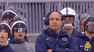 Man With Headphones In Front Of Penn State Hats GIF