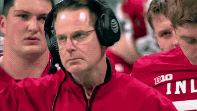 Man With Headphones In Front Of Red Shirt Players Saying Big GIF