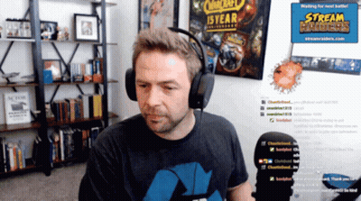 Man With Headphones In Front Of Stream Raider Sign GIF