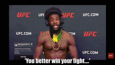 Man With Headphones In Front Of UFC Sign GIF