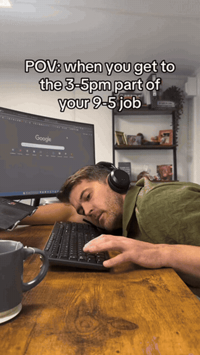 Man With Headphones Laying At Desk With Google Monitor GIF