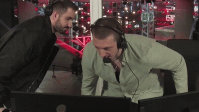 Man With Headphones Looking At Another Man At Computer GIF