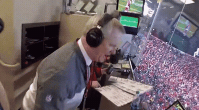 Man With Headphones Looking At Papers In Stadium GIF
