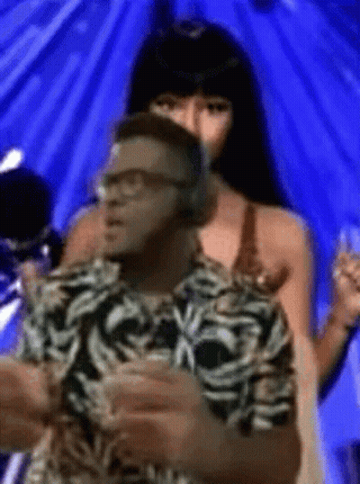 Man With Headphones Next To Woman In Bikini GIF