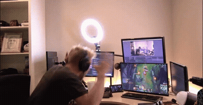 Man With Headphones Playing Video Game On Two Monitors GIF