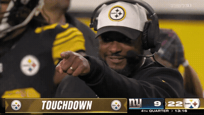 Man With Headphones Pointing At Touchdown Screen GIF