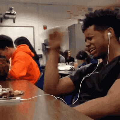 Man With Headphones Sitting In Classroom GIF