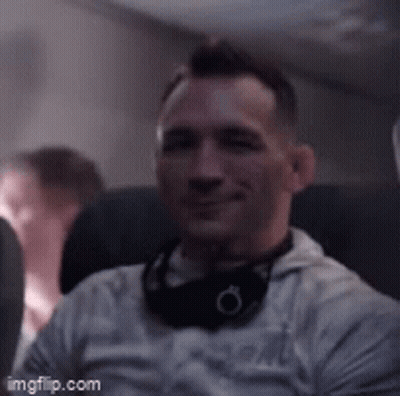 Man With Headphones Sitting On Airplane GIF