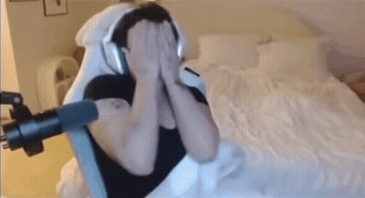 Man With Headphones Sitting On Bed GIF