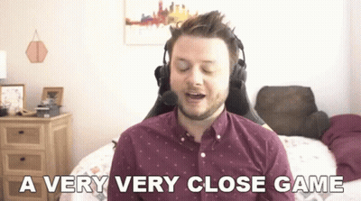 Man With Headphones Sitting On Bed Says Very Very Close Game GIF