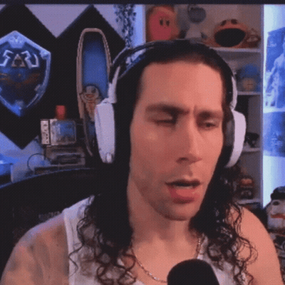 Man With Headphones Talking Into Microphone In Front Of Zelda Shield GIF