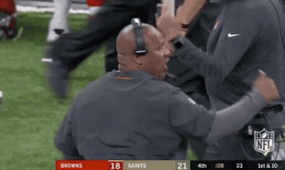 Man With Headphones Talking To Another On Football Field GIF