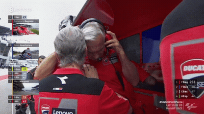Man With Headphones Talking To Man In Ducati Shirt GIF