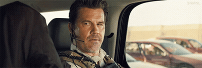 Man With Headset In Back Seat Looking Out Window GIF