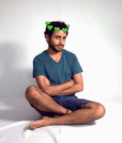 Man With Hearts On Head Sitting On Floor GIF