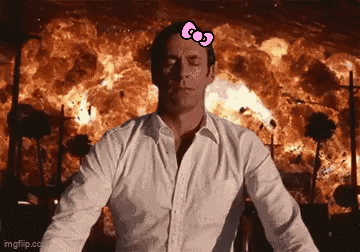 Man With Hello Kitty Bow Standing In Front Of Fire Explosion GIF