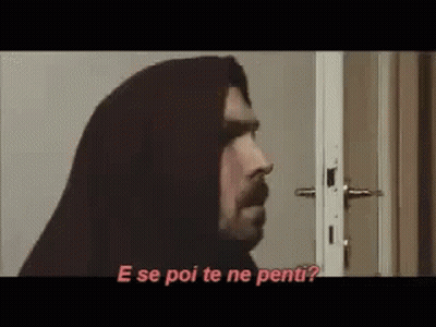 Man With Hood Standing In Front Of Door Talking GIF