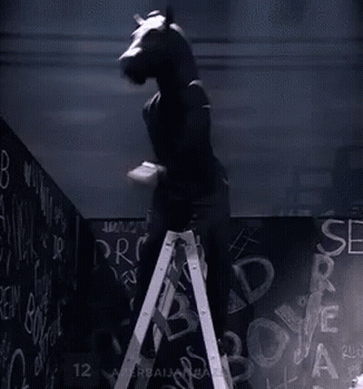 Man With Horse Head Standing On Ladder In Front Of Blackboard GIF