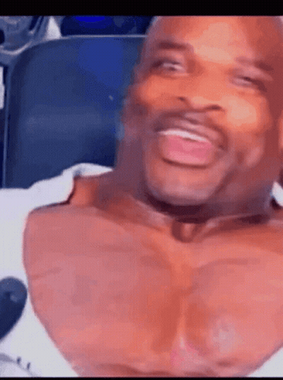 Man With Huge Chest Laughing In Chair GIF