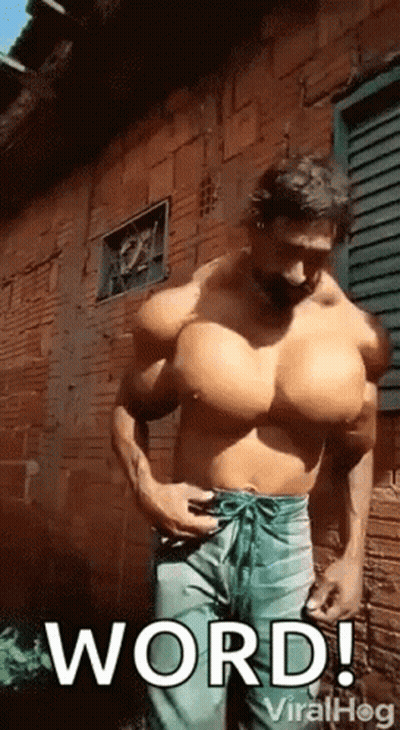 Man With Huge Muscles In Front Of Brick Building GIF