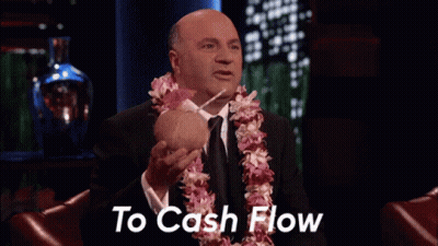 Man With Lei Holding Coconut And Straw Saying To Cash Flow GIF