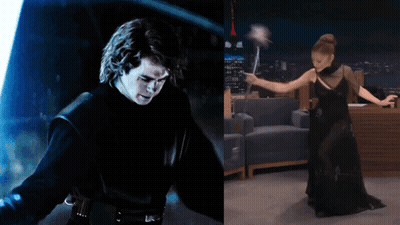 Man With Lightsaber Next To Woman In Black Dress Holding Wand GIF