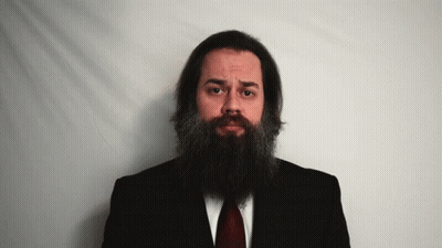 Man With Long Beard In Black Suit And Red Tie GIF