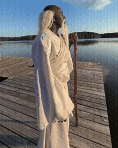 Man With Long Beard Standing On Wooden Dock GIF